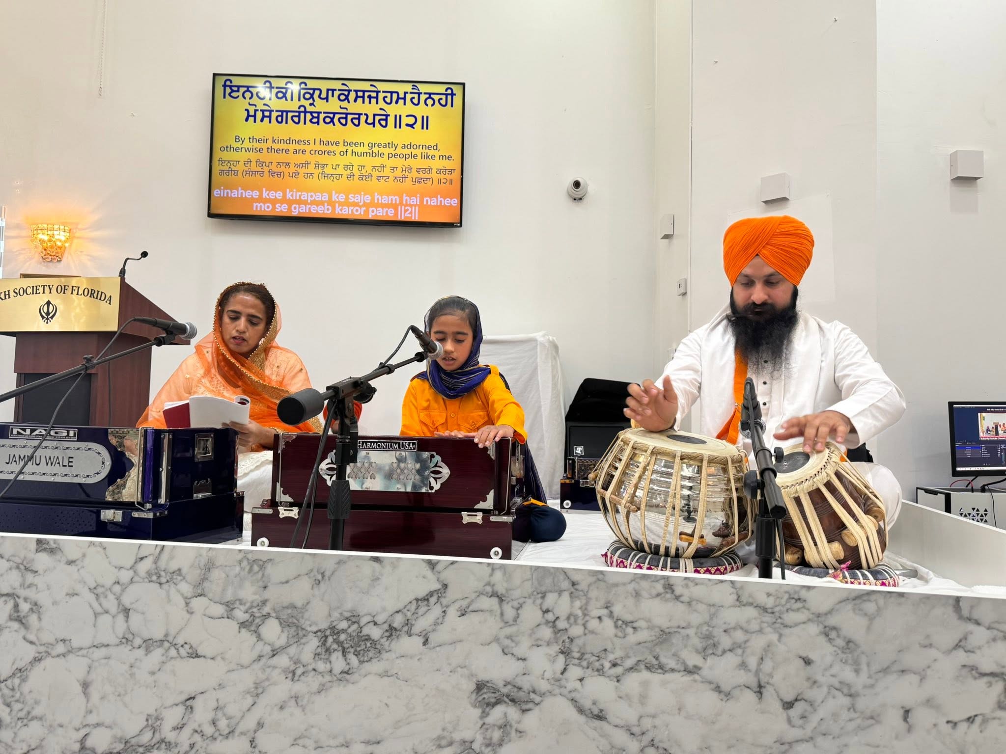 A young student learning Kirtan on the harmonium