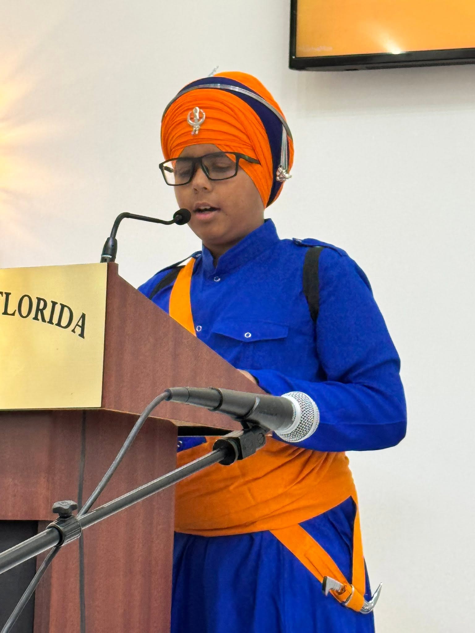A student speaking at the Sikh Society of Florida podium