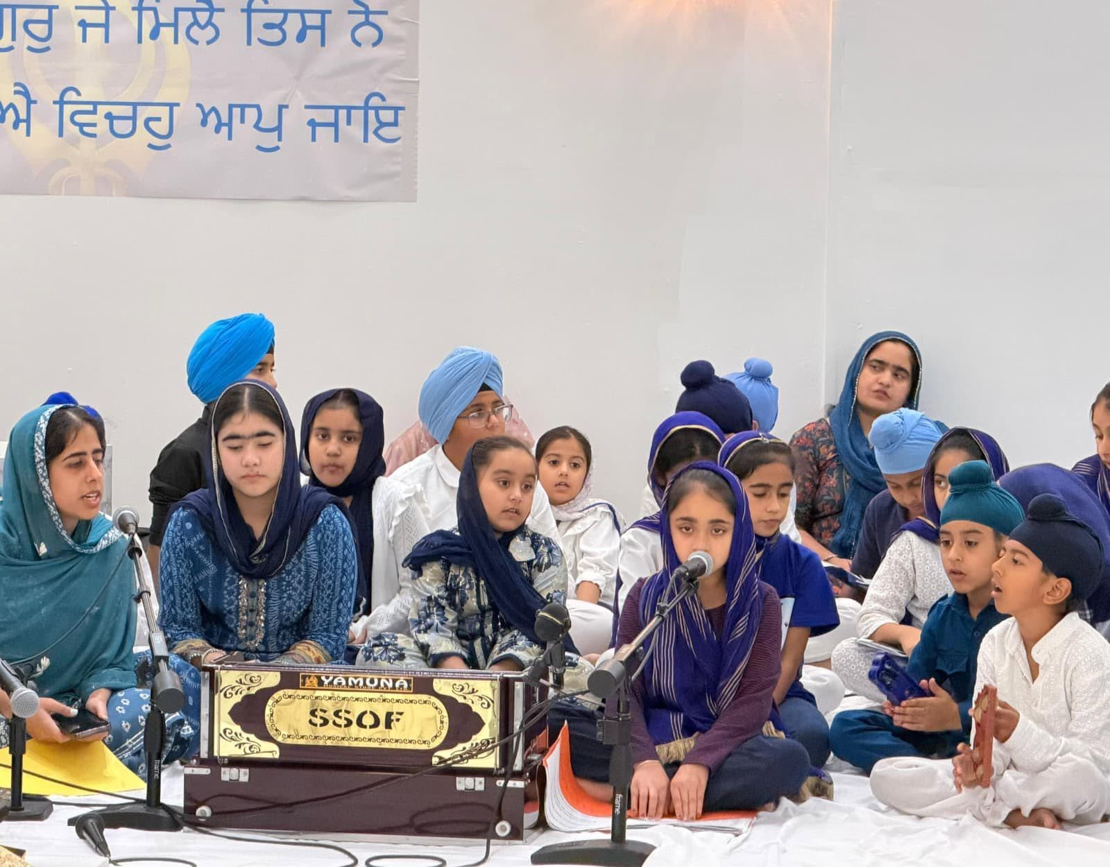 Children of the Punjabi School performing Kirtan on the harmonium