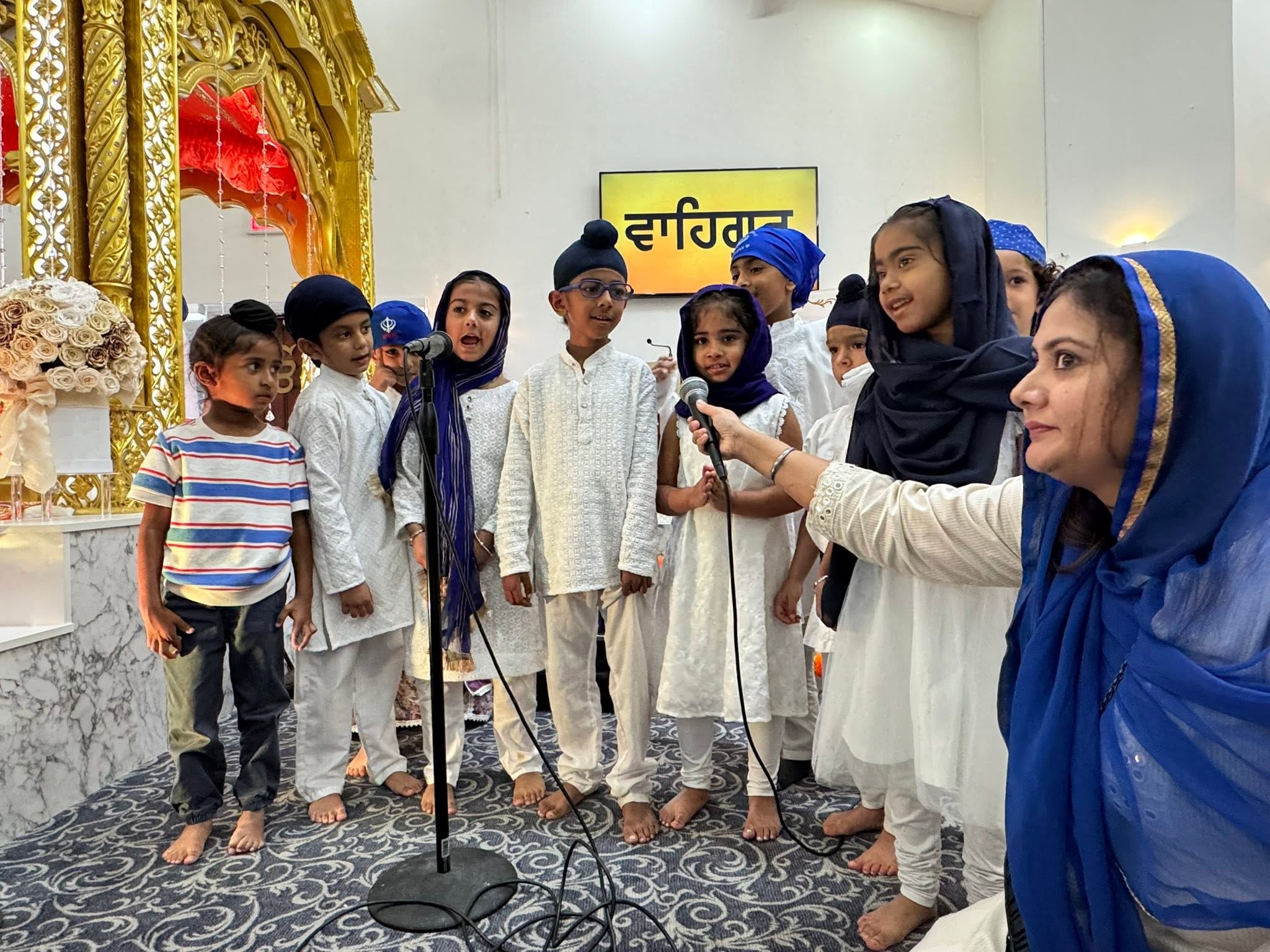 Young children singing together with a teacher