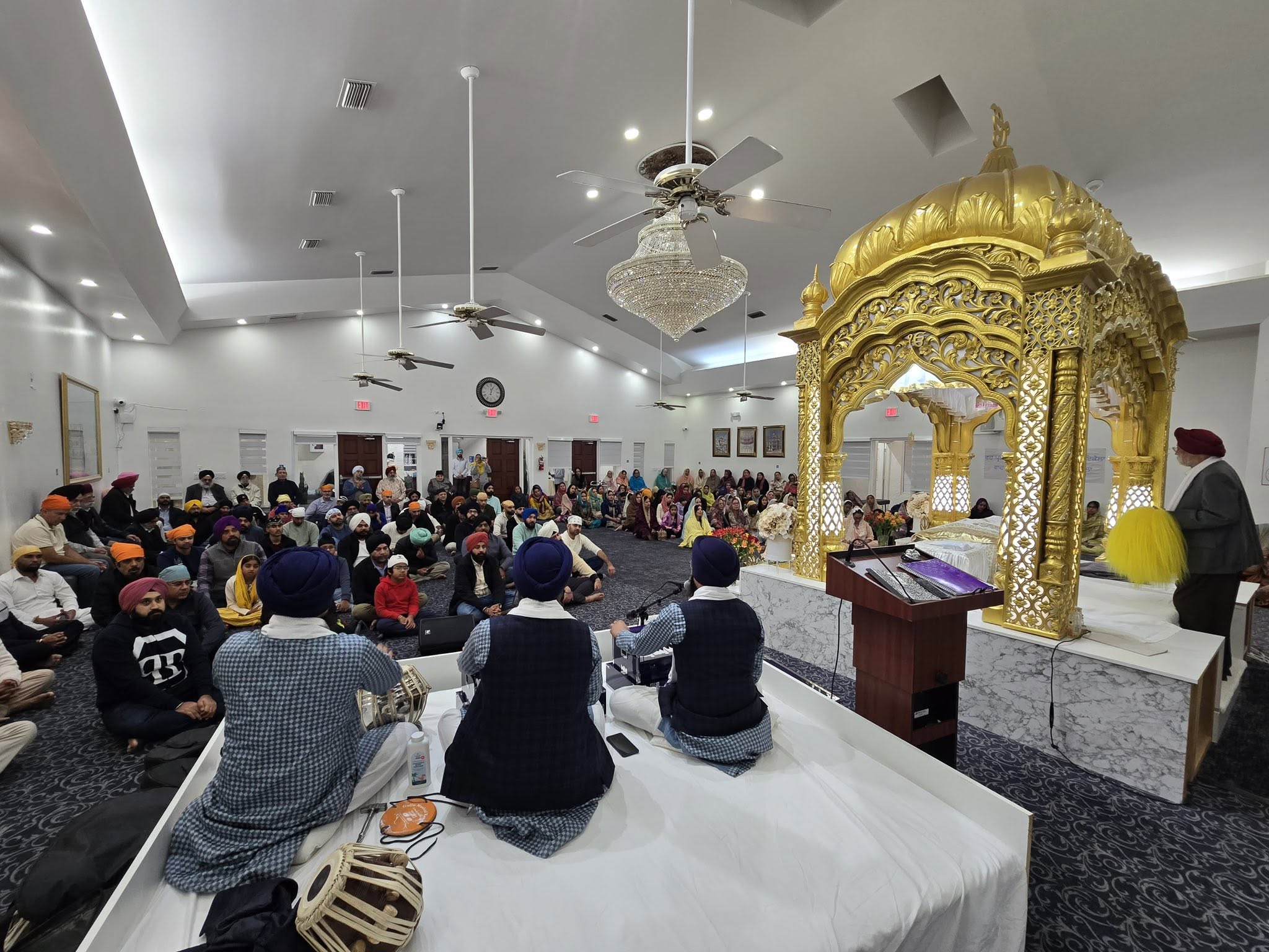 Ragi Jatha performing Kirtan on harmonium and tabla during a diwan
