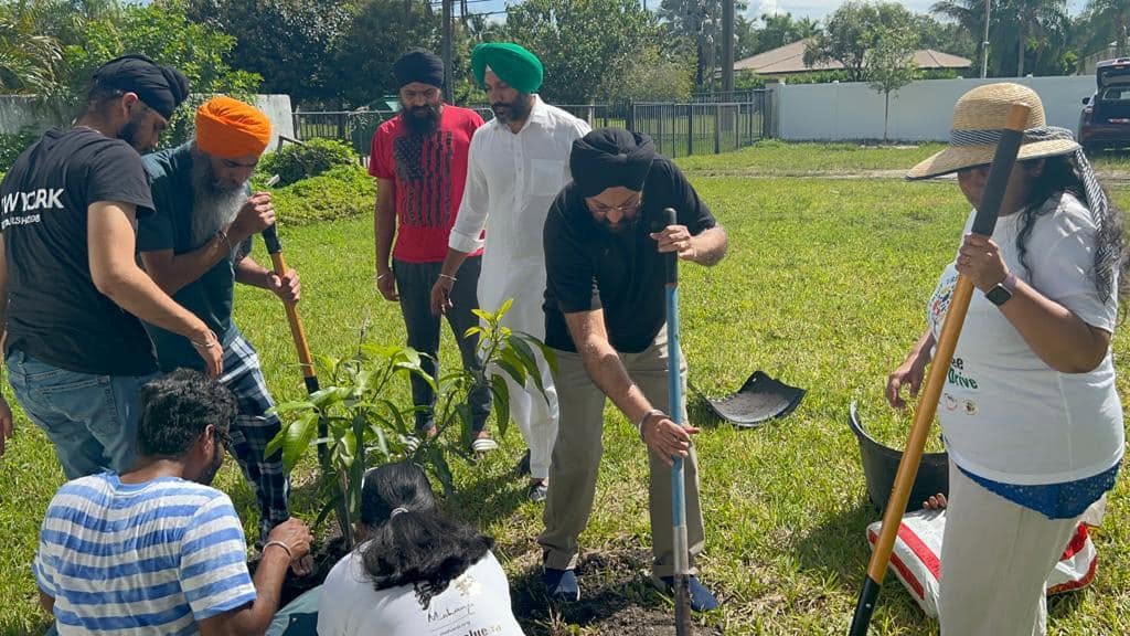 Sangat members planting trees together as an act of Seva and care for the environment